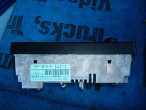 2001 Ford Crown Victoria - A car radio part is shown against a blue background with text.