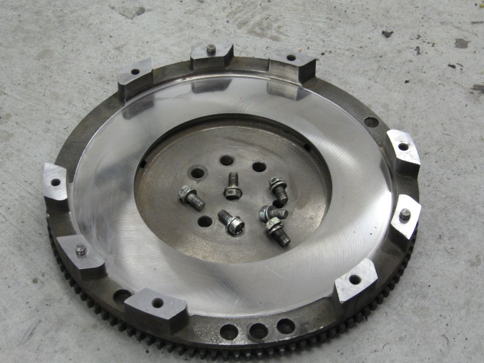 Clutch flywheel with several bolts scattered on its surface