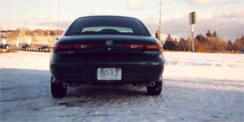 1999 Mercury Sable - A close up of the muffler setup behind the car. You can actually see the terrible mounting job I did on that passenger side muffler.