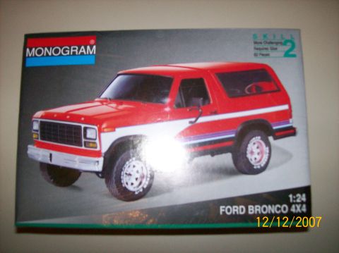 1979 Ford Bronco - The lid of a Monogram 1:24 scale "Ford Bronco 4x4" model kit box, showing the built model as a red-and-white two-tone Bronco in three-quart…