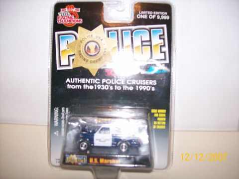 1979 Ford Bronco - A sealed Racing Champions "Police" limited-edition die-cast blister pack, one of 9,999, holding a blue-and-white U.S. Marshal Bronco-style…