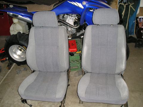 1986 Toyota Hilux - Two grey fabric car seats are shown, likely removed for cleaning or repair.
