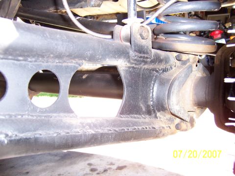 1994 Ford Bronco - Close-up view of vehicle suspension components, showing metalwork and a coil spring.
