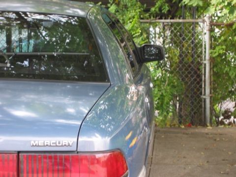 1993 Mercury Grand Marquis - Rear view of a 1993 Mercury Grand Marquis showing the taillight and quarter panel.