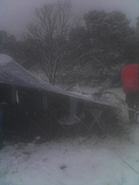 1997 Ford F-250 - A vehicle is partially obscured by snow and fog, with a person in a red jacket visible on the right side.