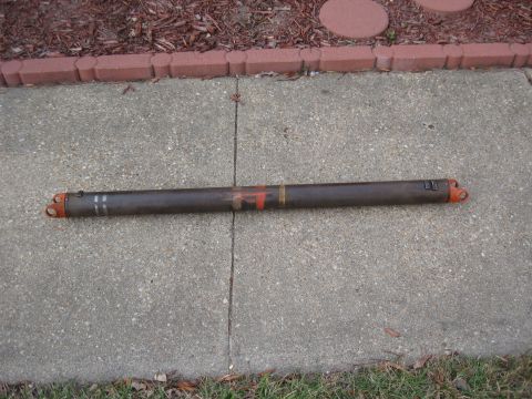 1968 Shelby GT500 - A driveshaft with orange U-joints and painted identification marks lies on a concrete surface.