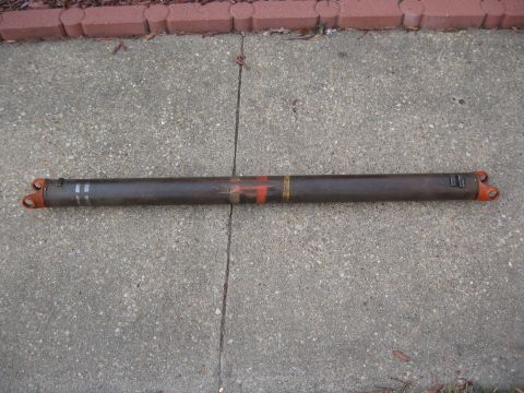 1968 Shelby GT500 - This is a driveshaft with orange U-joints and painted markings on a concrete surface.