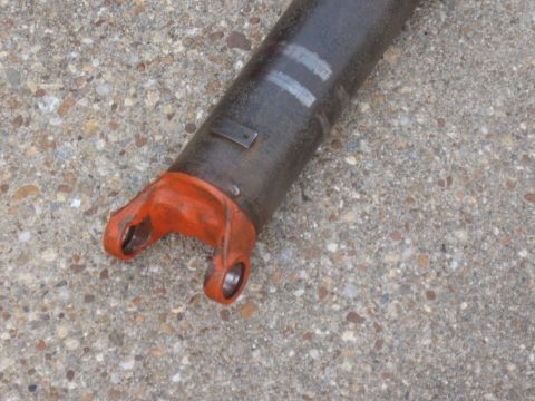 1968 Shelby GT500 - A close-up view of a driveshaft yoke, showing the U-joint connection point with orange paint and some markings on the shaft.