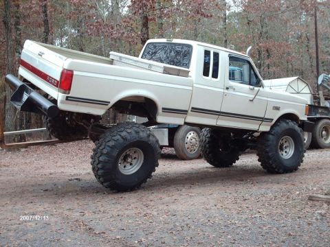 1990 Ford F-150 - This modified Ford F-150 pickup truck features a lifted suspension and massive off-road tires.