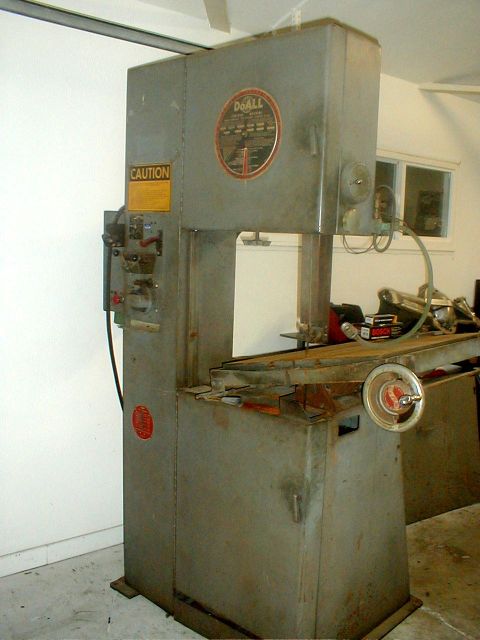 1996 Ford Bronco - A DoAll band saw is shown with a caution label and a circular manufacturer's emblem.