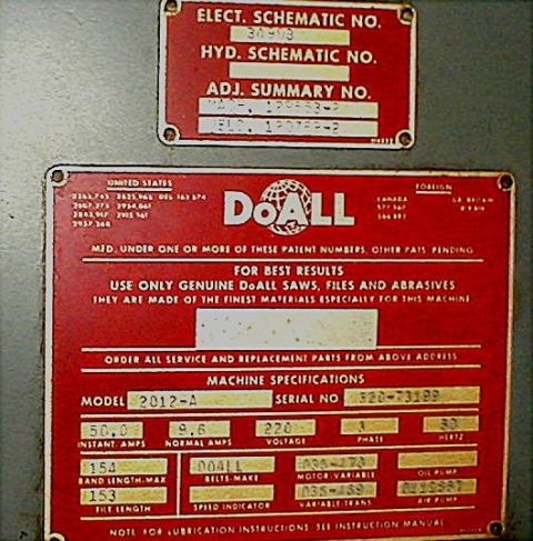 1996 Ford Bronco - Close-up of two machine identification plates, one with electrical and hydraulic schematic numbers, the other with model and serial numbers.