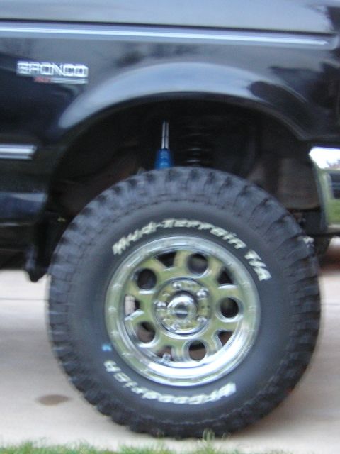 1994 Ford Bronco - The side view shows a large tire and wheel assembly on a vehicle with a visible 'Bronco' badge.