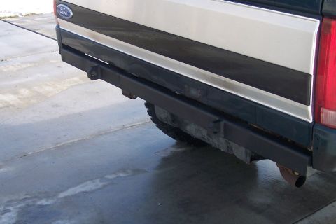 1995 Ford Bronco - This image shows the rear of a Ford Bronco, a custom black bumper and a visible tire.