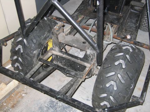 2001 Ford F-150 - The frame of a custom-built vehicle is shown from the rear, large tires and exposed mechanical parts.