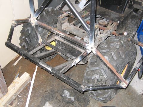 2001 Ford F-150 - The rear section of a custom-built vehicle shows a metal frame and large off-road tires.