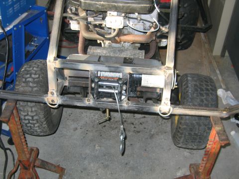 2001 Ford F-150 - Custom lawnmower build a winch and engine components, supported by jack stands.