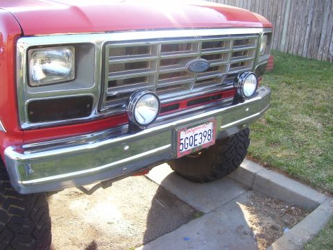 1986 Ford Bronco - Front view of a red 1986 Ford Bronco showing its grille and headlights.