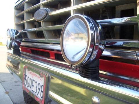 1986 Ford Bronco - Close-up of a vintage Ford Bronco's front grille, auxiliary lights and a California license plate.