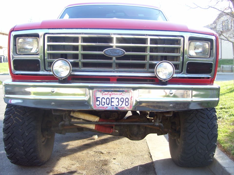 Red 1986 Ford Bronco front view with chrome grille and California license plate 5GOE398