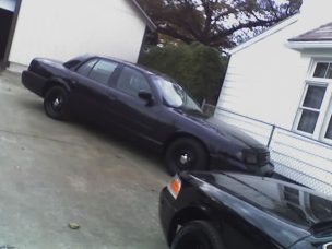 1999 Ford Crown Victoria - Mine by a black ex sheriffs car