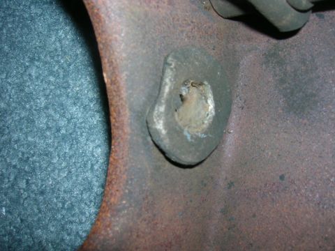 1979 Ford Bronco - A close-up view of a corroded metal bracket, showing a worn hole and rust. The Supermotors.net watermark is present.