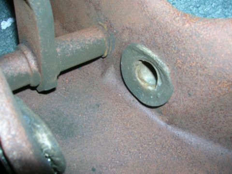 1979 Ford Bronco - Close-up of a rusty exhaust manifold part, showing signs of wear and age.
