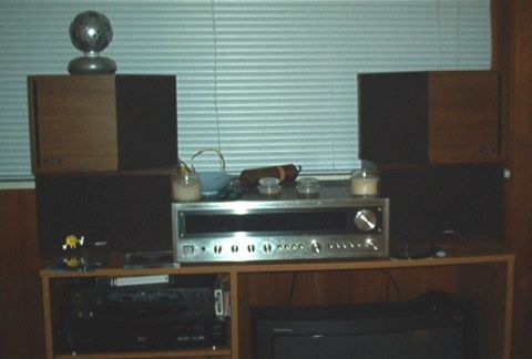 1985 Ford LTD Crown Victoria - Audio equipment setup including a receiver and multiple speakers, with decorative items on top.