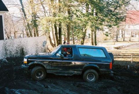 1995 Ford Bronco - This 1995 Ford Bronco navigates a muddy terrain, its off-road capabilities.