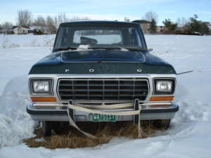 1984 Ford Bronco - Front view of a green Ford Bronco parked in the snow.