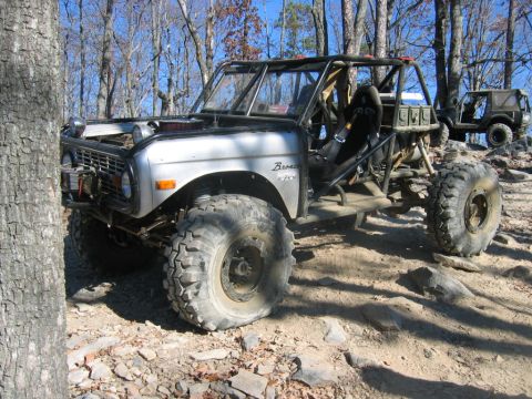 1992 Ford Mustang - Modified 1970 Ford Bronco buggy on rocky terrain, with another vehicle in the background.
