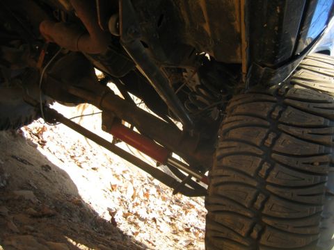 1992 Ford Mustang - Close-up of a vehicle's undercarriage, focusing on suspension and a tire.