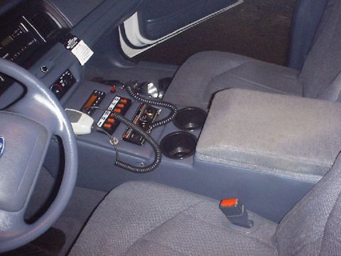 2002 Ford Crown Victoria - Interior view of a 2002 Ford Crown Victoria, highlighting the center console and police equipment.