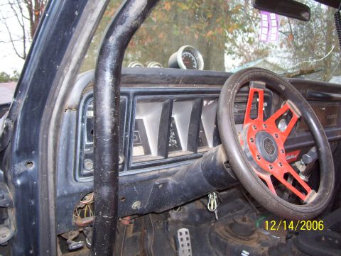 1978 Ford Bronco - Interior view of a 1978 Ford Bronco, a custom steering wheel and roll cage.