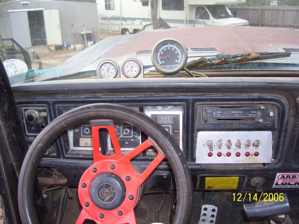 Dashboard with aftermarket steering wheel, gauges, and switches. Date stamp shows 12/14/2006