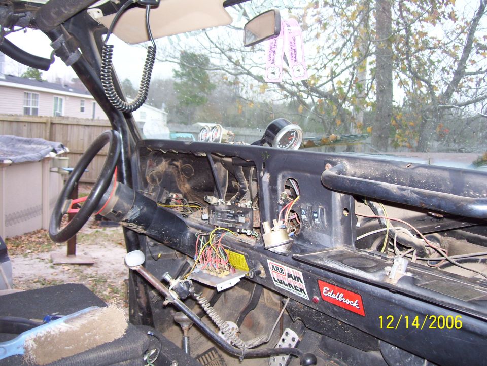 Interior view of a vehicle dashboard with wiring exposed, steering wheel visible. Date stamp reads 12/14/2006