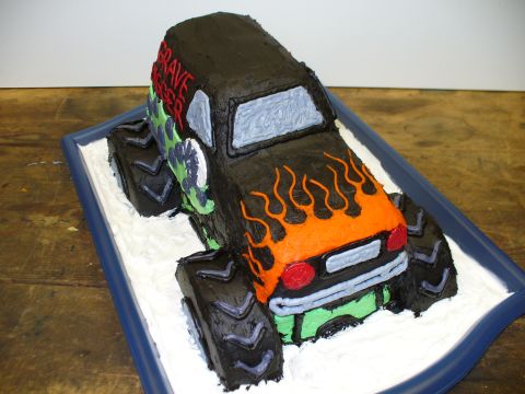 1978 Ford Bronco - A cake decorated to resemble a monster truck, complete with flames and the name 'Grave Digger'.