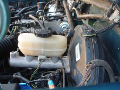 1996 Ford F-150 - Close-up view of the brake booster and master cylinder assembly in a 1996 Ford F-150.