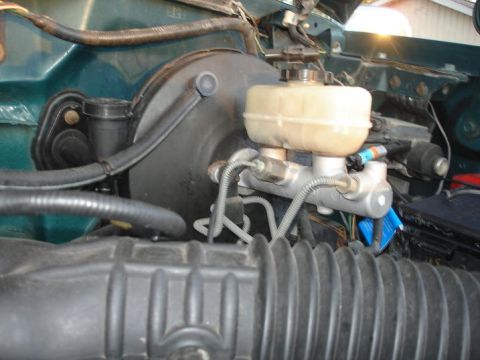 1996 Ford F-150 - Close-up view of the brake booster and master cylinder assembly in a 1996 Ford F-150.
