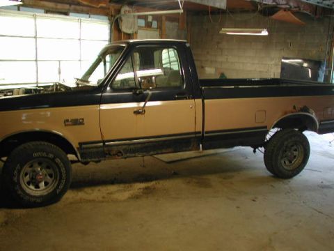 1988 Ford F-150 - This 1988 Ford F-150 pickup truck is shown in a side profile, a two-tone paint scheme of brown and black.