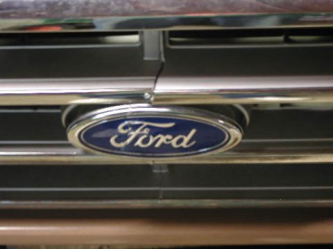 1988 Ford F-150 - Close-up of the Ford emblem on the front grille of a 1988 Ford F-150.