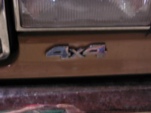 1988 Ford F-150 - Close-up of a 4x4 badge on the exterior of a vehicle.