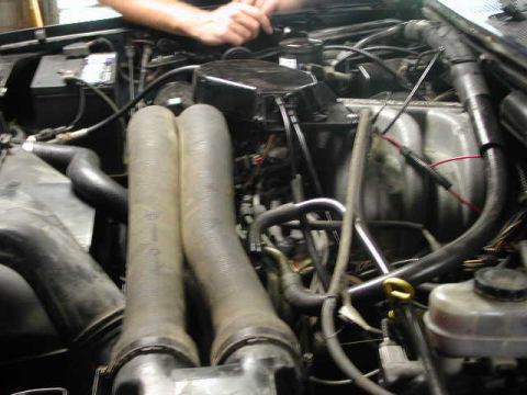 1988 Ford F-150 - Close-up view of an engine bay, focusing on the intake system and surrounding components.