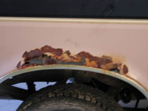 1988 Ford F-150 - Extensive rust is visible on the fender lip above the tire of a truck.