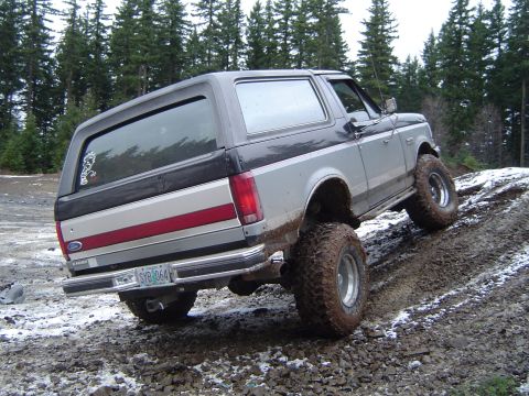 1989 Ford Bronco - This 1989 Ford Bronco is navigating a challenging off-road course with mud and snow.