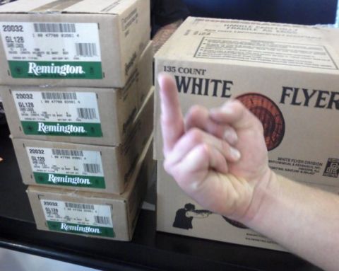 1993 Ford Bronco - A hand is shown giving the middle finger in front of stacked boxes of Remington shotgun shells and White Flyer clay targets.