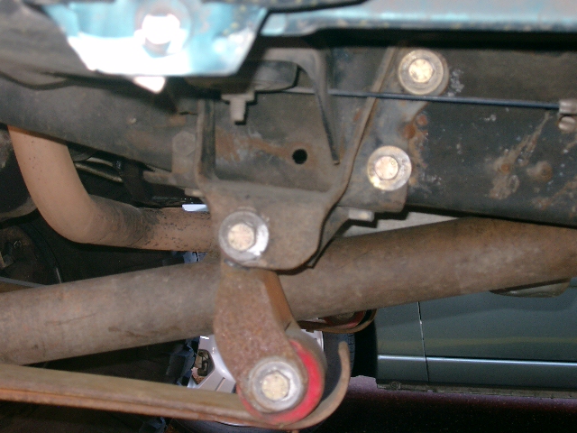 Underside of a vehicle showing crossmember, exhaust and suspension link