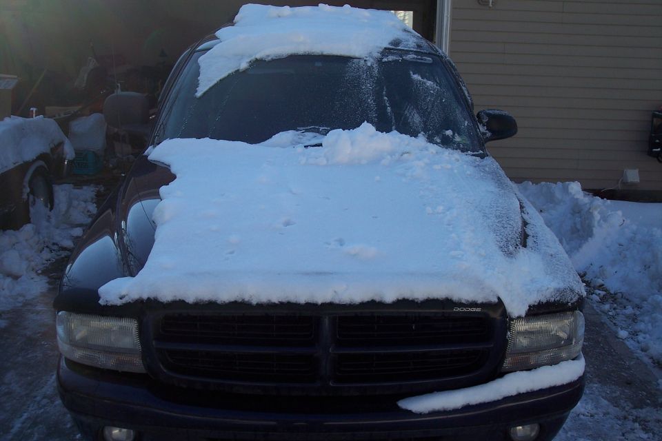 Front view of a 2007 Dodge Durango covered in snow