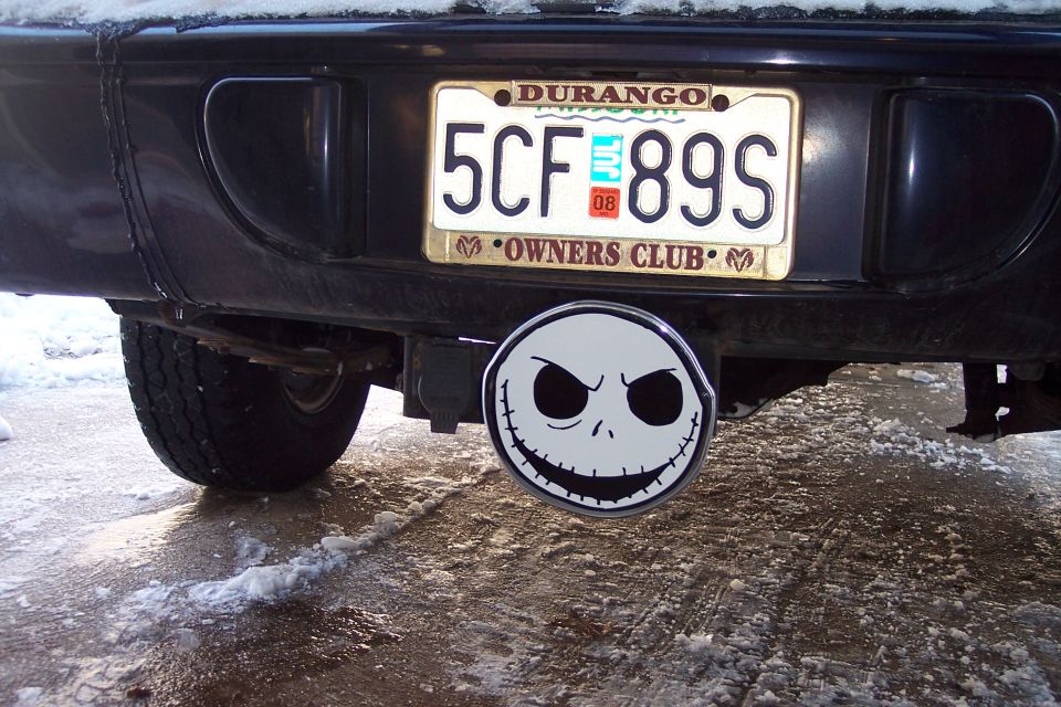Rear bumper with Durango Owners Club plate frame and skull-face hitch cover in snow