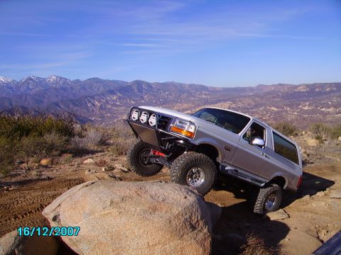 1990 Ford Bronco - This 1990 Ford Bronco navigates a rocky trail with a custom front bumper and auxiliary lights.