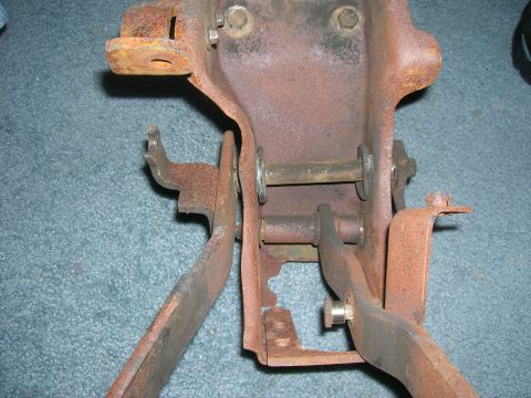 1979 Ford Bronco - Close-up view of a heavily rusted clutch pedal assembly, showing its mechanical components and pivot points.